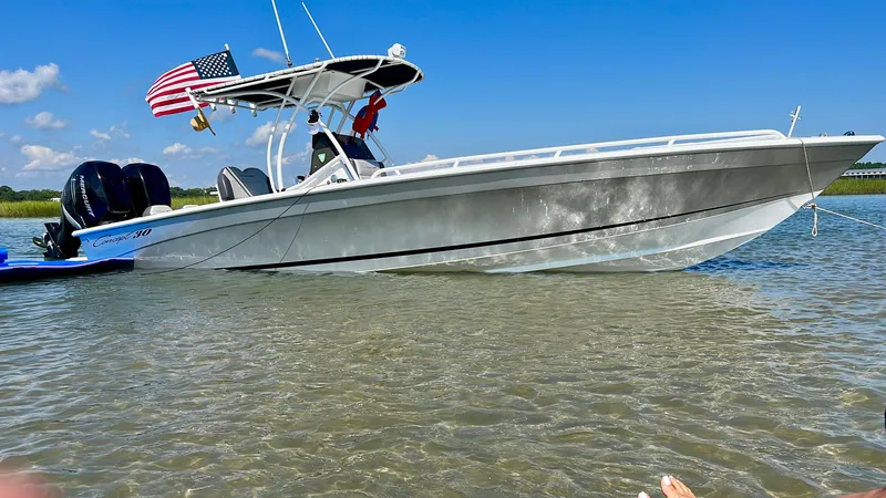 Slide: The Image of Concept 30CC 2017 boat anchored in shallow water, American flag displayed. - 0