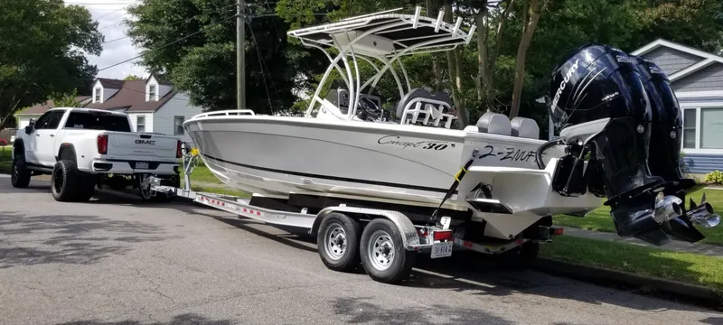Slide: The Image of A 2017 Concept 30CC boat on a trailer, towed by a GMC truck in a suburban neighborhood. - 4