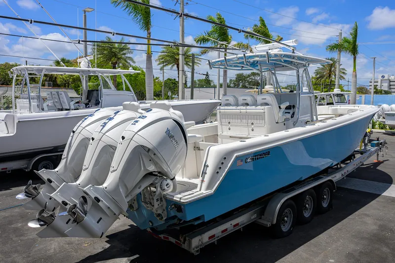 Slide: The Image of 2022 Contender 35 ST boat with dual engines on a trailer, parked outdoors. - 11