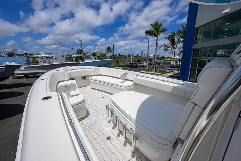 Slide: The Image of 2022 Contender 35 ST boat with spacious seating, docked under a sunny sky. - 14