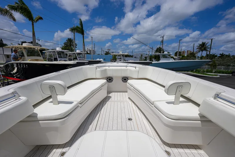 Slide: The Image of 2022 Contender 35 ST boat with spacious seating, under a clear blue sky. - 16