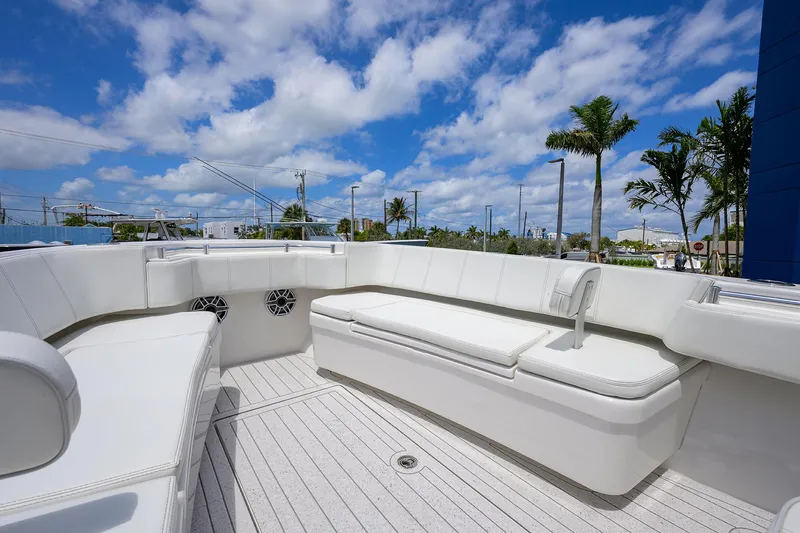 Slide: The Image of 2022 Contender 35 ST boat with spacious white seating under a blue sky. - 17