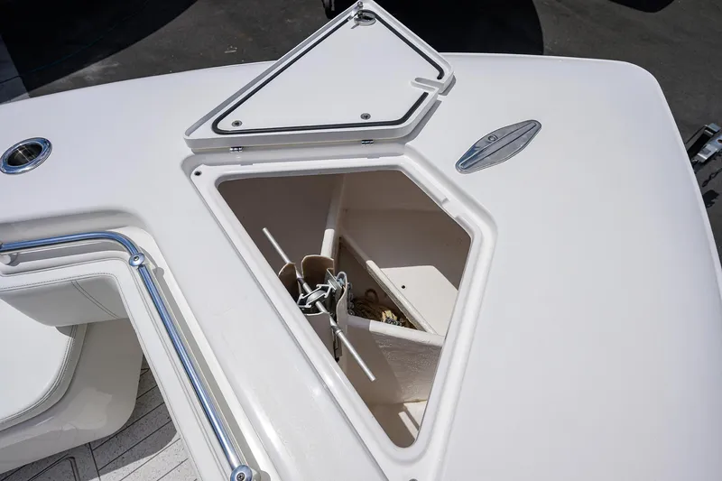 Slide: The Image of 2022 Contender 35 ST boat anchor storage compartment, open lid, white interior. - 19