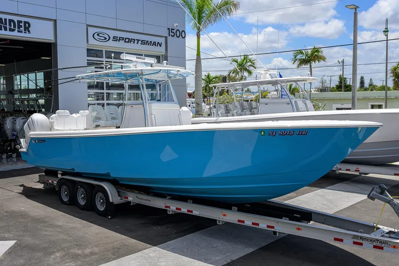 Slide: The Image of 2022 Contender 35 ST boat on trailer outside dealership, vibrant blue hull. - 2