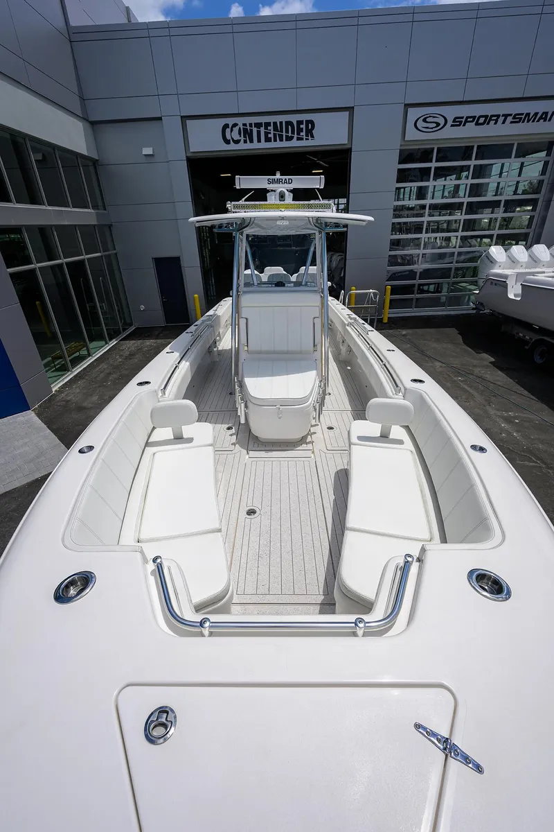 Slide: The Image of 2022 Contender 35 ST boat at dealership, showcasing spacious deck and seating. - 20