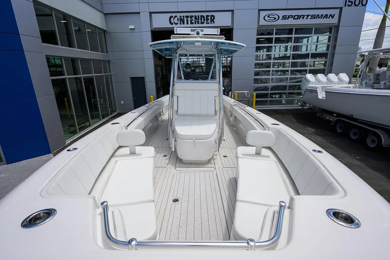 Slide: The Image of 2022 Contender 35 ST boat with spacious deck and seating, displayed at dealership. - 21