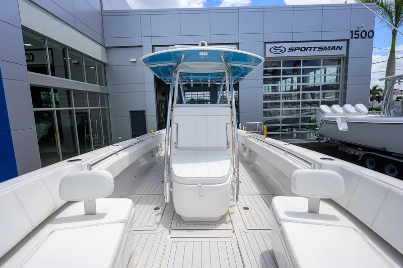 Slide: The Image of 2022 Contender 35 ST boat with sleek design at dealership, showcasing spacious interior and modern features. - 22