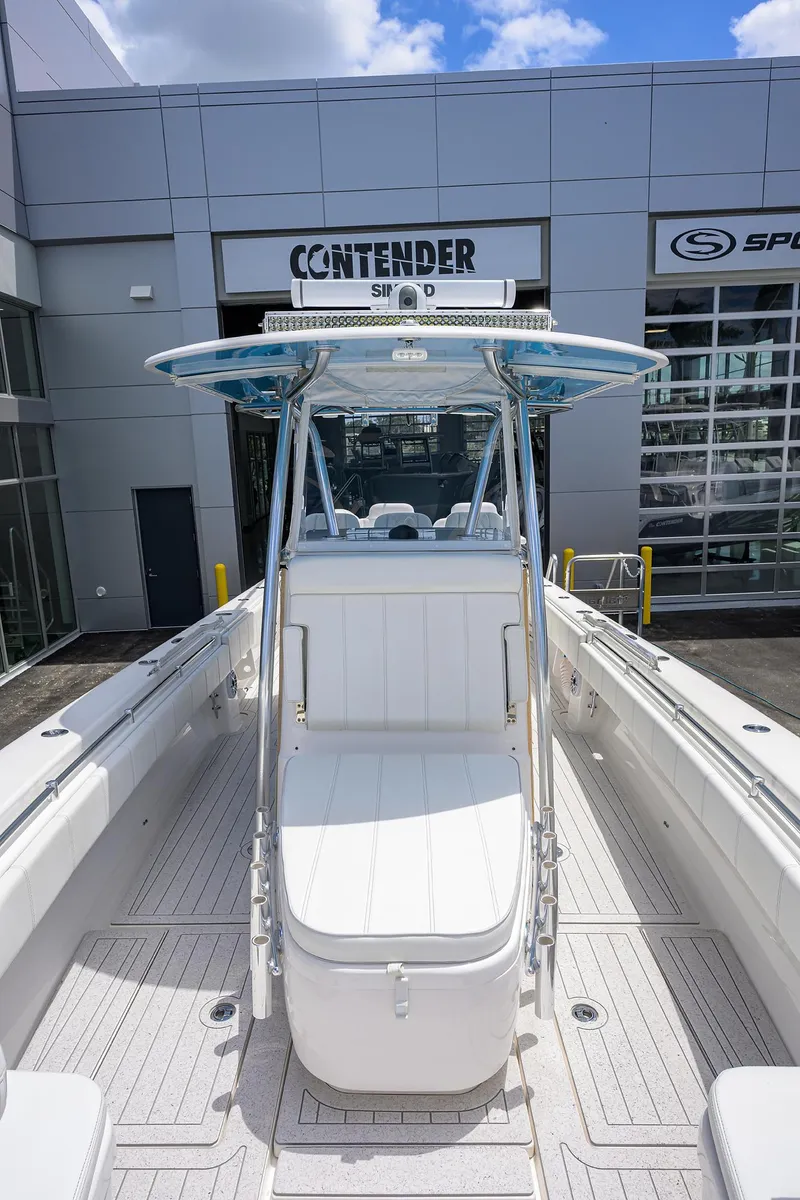 Slide: The Image of 2022 Contender 35 ST boat at dealership, showcasing sleek design and spacious deck. - 23