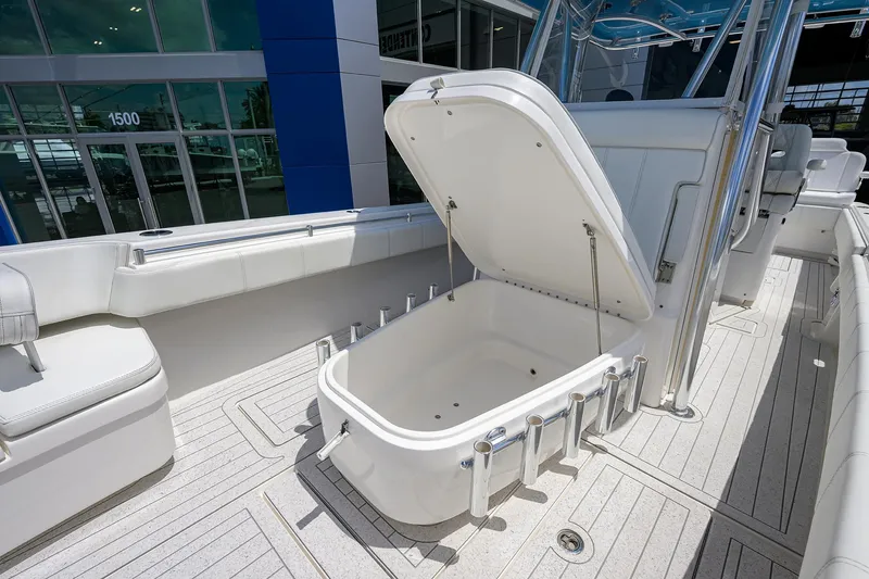 Slide: The Image of 2022 Contender 35 ST boat with open storage compartment on deck. - 30