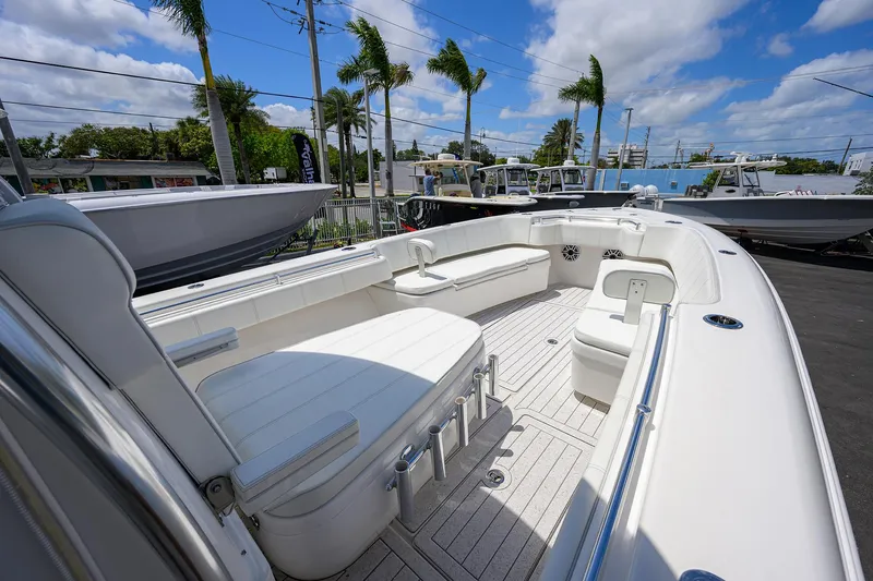 Slide: The Image of 2022 Contender 35 ST boat with spacious seating and sleek design under a sunny sky. - 32