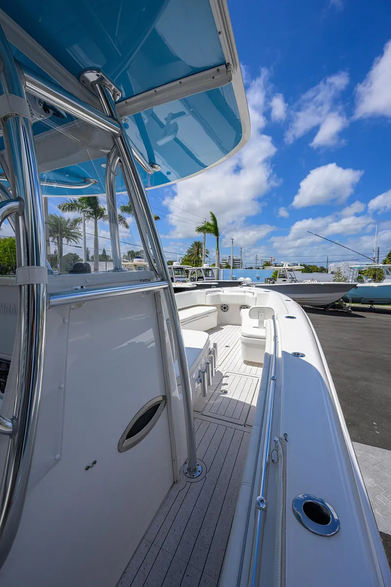 Slide: The Image of 2022 Contender 35 ST boat, sleek design, docked under a bright blue sky. - 33