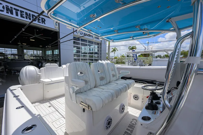 Slide: The Image of 2022 Contender 35 ST boat interior with white seating and blue canopy. - 36