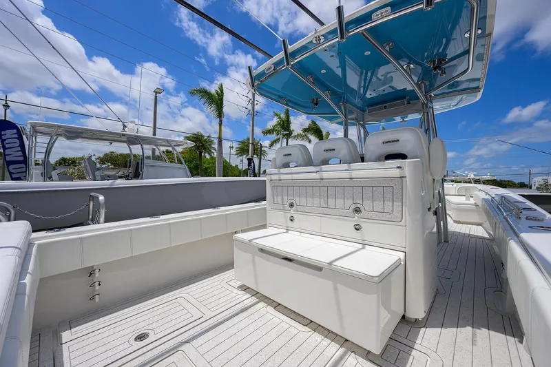 Slide: The Image of 2022 Contender 35 ST boat interior with seating, under a blue sky. - 42