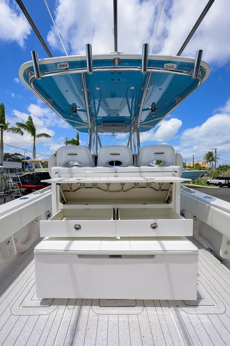 Slide: The Image of 2022 Contender 35 ST boat with open storage, sleek design, and blue canopy. - 44