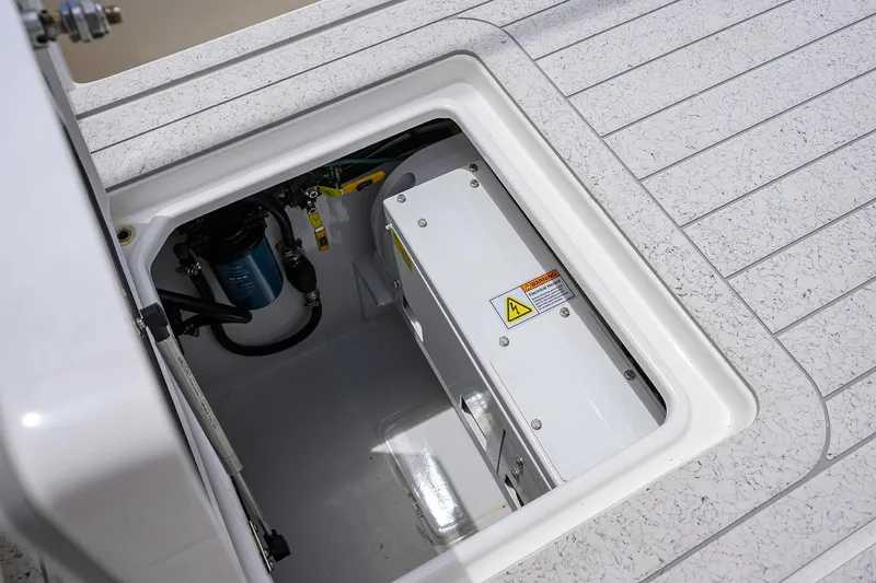 Slide: The Image of 2022 Contender 35 ST boat storage compartment with electrical components and wiring. - 48