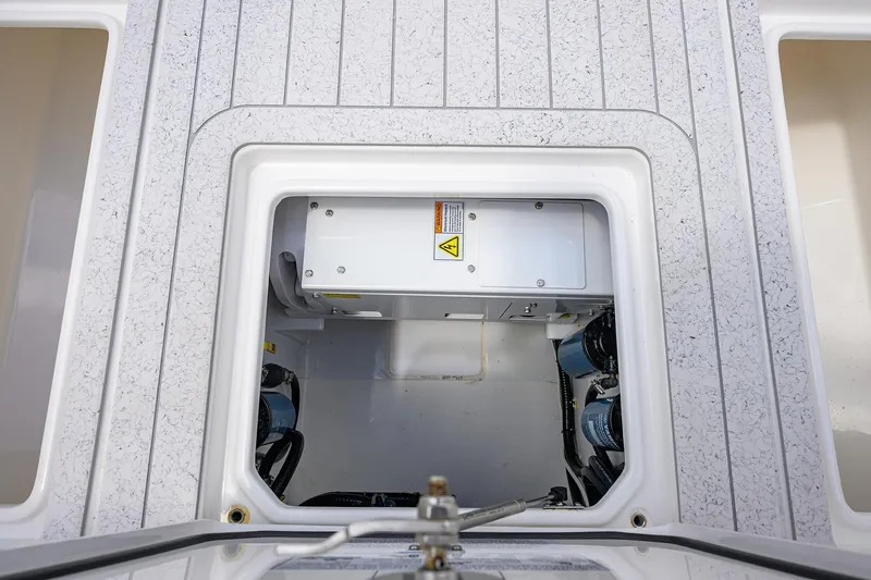 Slide: The Image of 2022 Contender 35 ST boat storage compartment with visible equipment and wiring. - 49