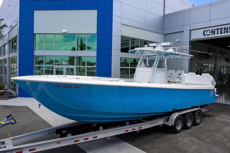 Slide: The Image of 2022 Contender 35 ST boat in blue on a trailer outside a dealership. - 5