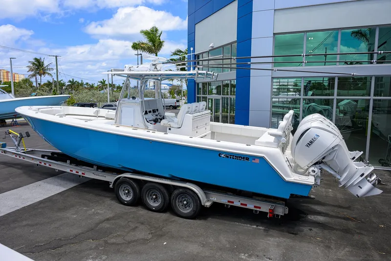 Slide: The Image of 2022 Contender 35 ST boat on trailer, blue hull, parked outside dealership. - 7
