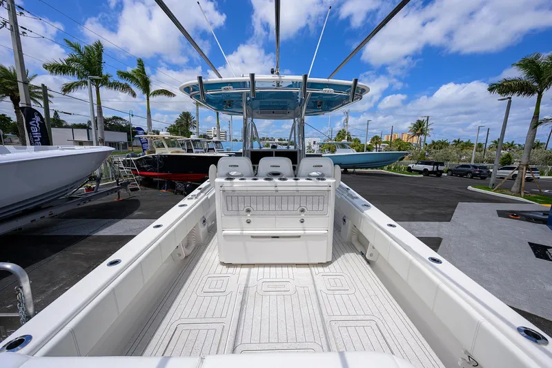 Slide: The Image of 2022 Contender 35 ST boat interior with seating, under a clear blue sky. - 9