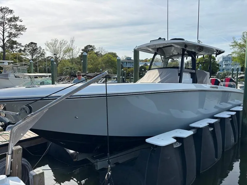 Slide: The Image of 2024 Fountain 34 TE boat docked at a marina, showcasing sleek design and modern features. - 1