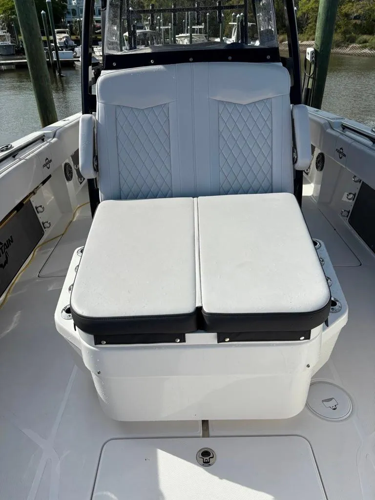 Slide: The Image of 2024 Fountain 34 TE boat interior with cushioned seating and storage. - 10