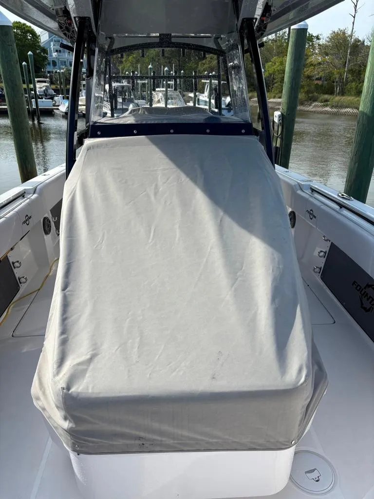 Slide: The Image of 2024 Fountain 34 TE boat with covered console, docked at marina. - 11