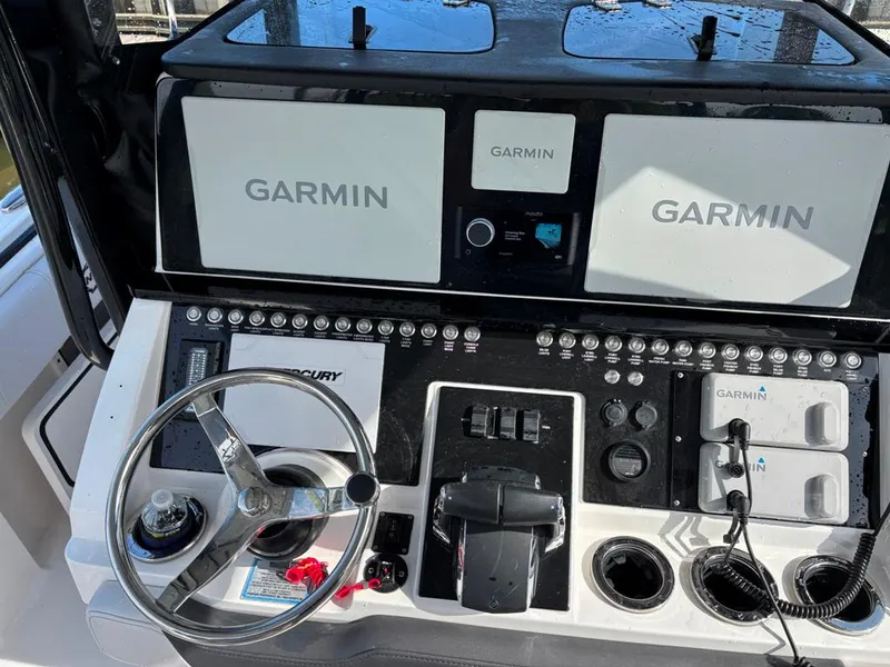 Slide: The Image of Control panel of 2024 Fountain 34 TE boat with Garmin navigation displays. - 2