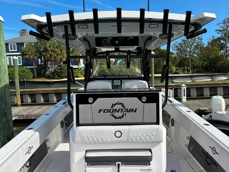 Slide: The Image of 2024 Fountain 34 TE boat docked, featuring a sleek design and spacious deck. - 3