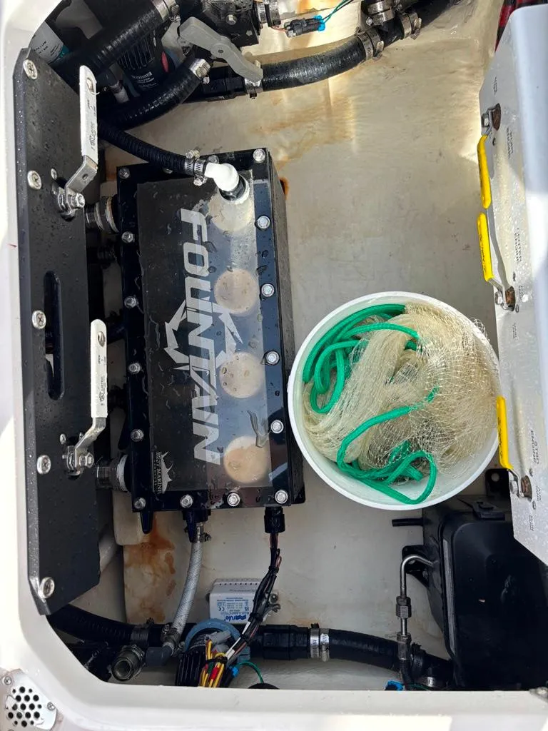 Slide: The Image of 2024 Fountain 34 TE boat engine compartment with equipment and storage. - 9
