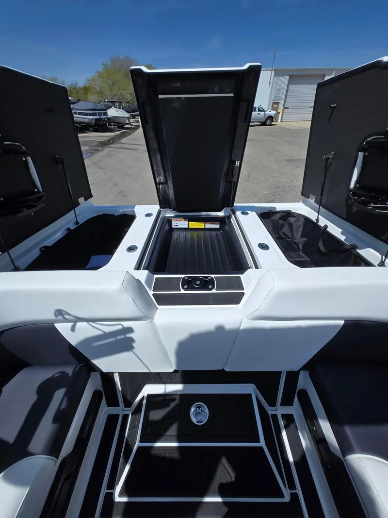 Slide: The Image of 2025 Moomba Craz boat interior with open storage compartments, showcasing sleek design and functionality. - 11