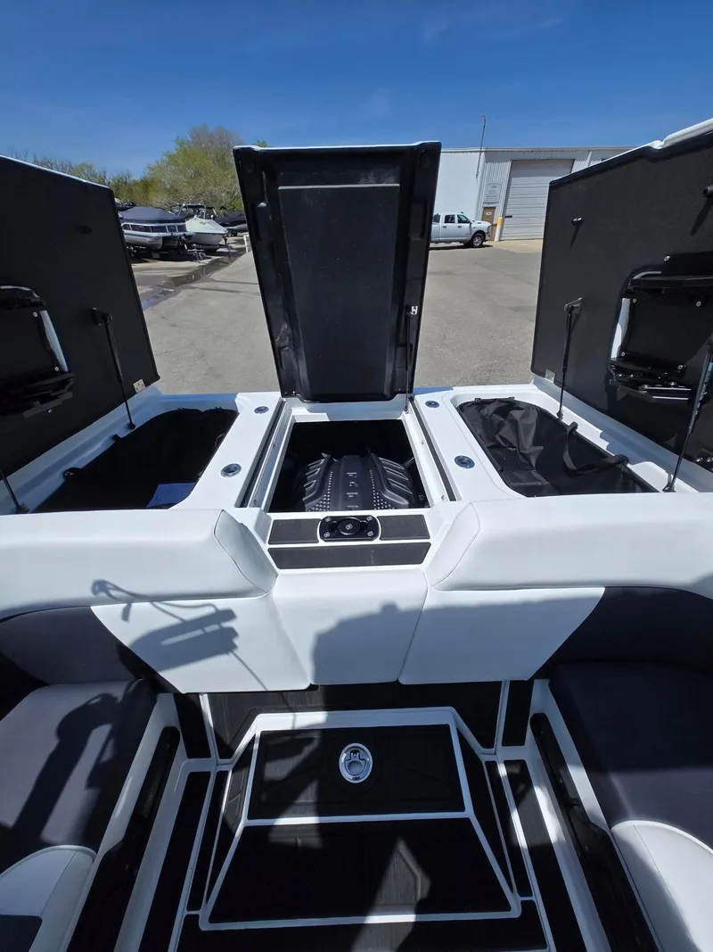 Slide: The Image of 2025 Moomba Craz boat interior with open engine compartment, showcasing sleek design. - 12