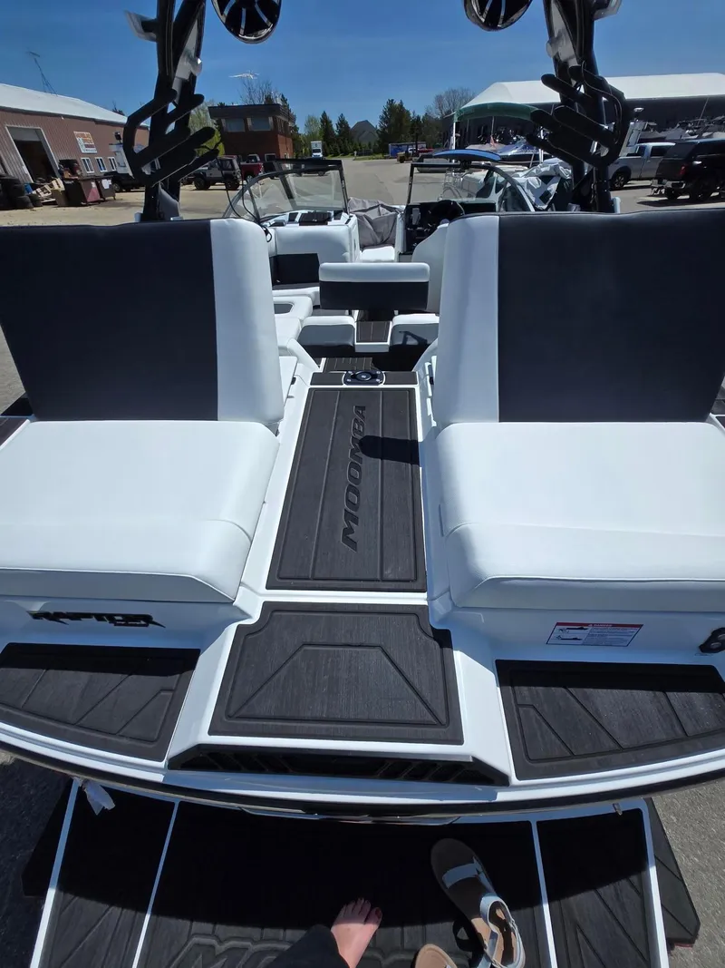Slide: The Image of 2025 Moomba Craz boat interior with white seating and black flooring. - 16