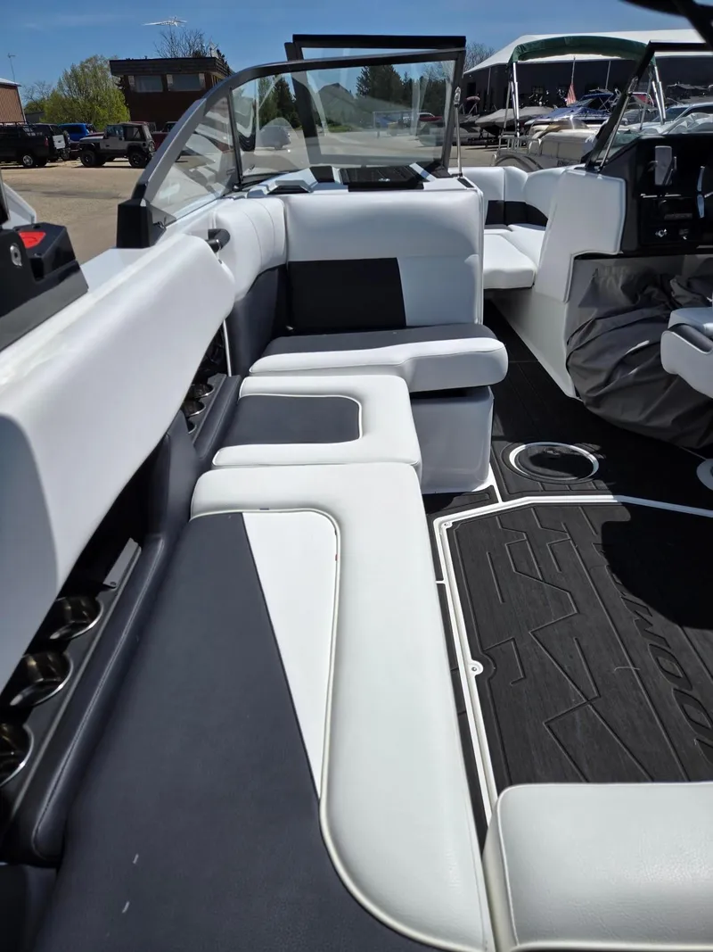 Slide: The Image of 2025 Moomba Craz boat interior with sleek white and black seating design. - 19