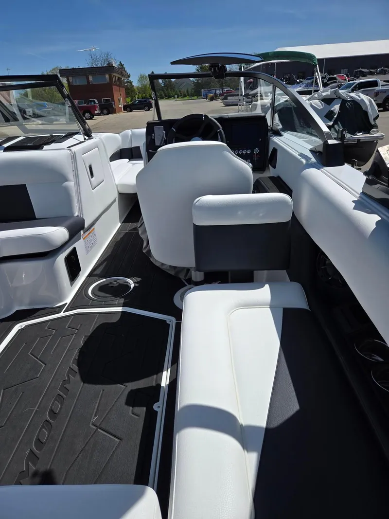 Slide: The Image of 2025 Moomba Craz boat interior with white seating and modern dashboard. - 20