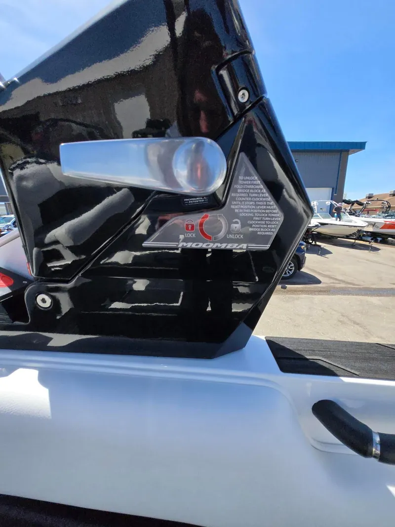 Slide: The Image of 2025 Moomba Craz boat detail, featuring a black and white exterior with lock mechanism. - 22