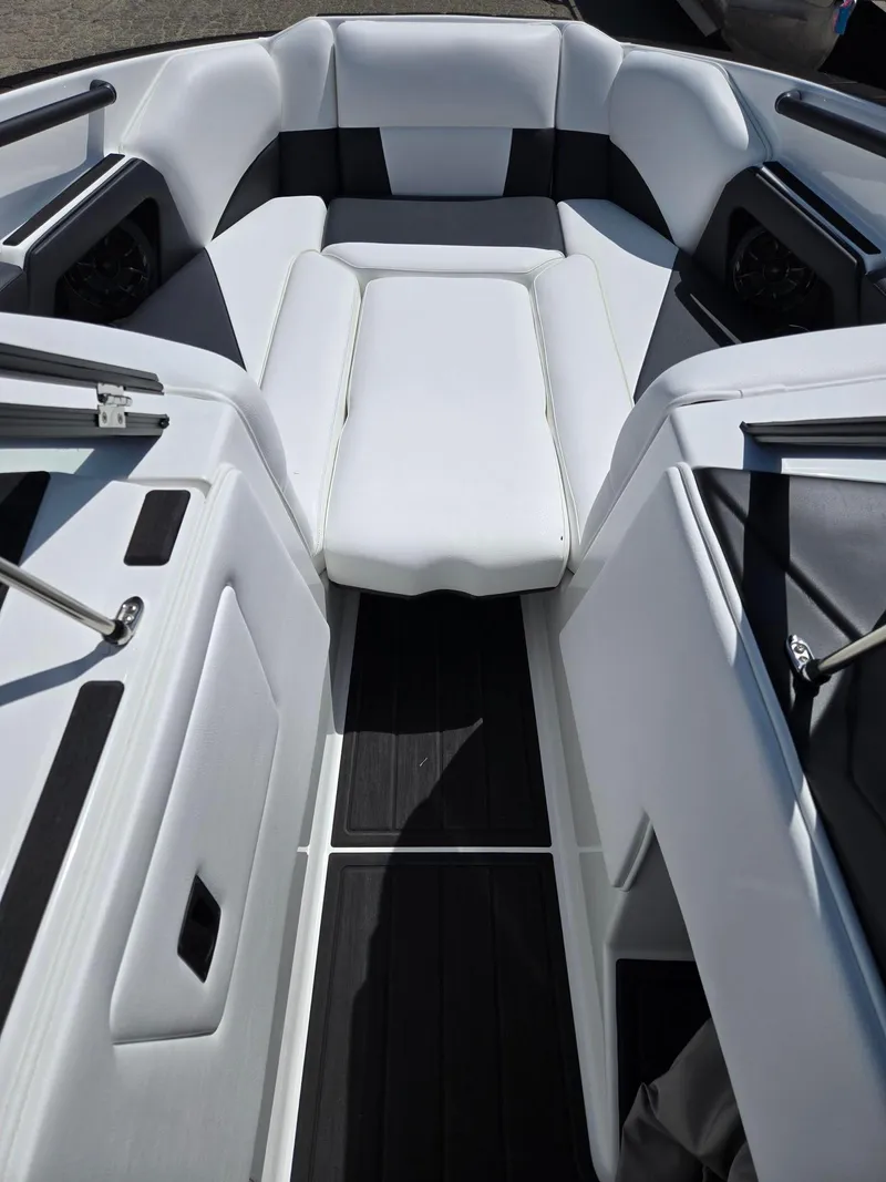 Slide: The Image of 2025 Moomba Craz boat interior with white seating and black accents. - 23