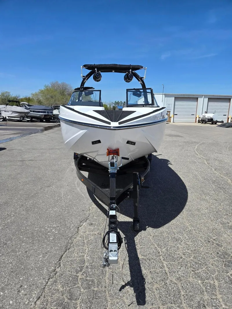Slide: The Image of 2025 Moomba Craz boat on trailer, parked outdoors under clear blue sky. - 3