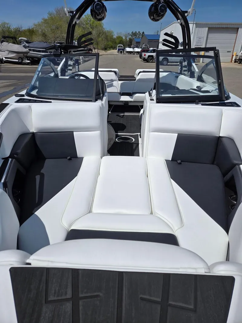 Slide: The Image of 2025 Moomba Craz boat interior with white and black seating, open-air design. - 4