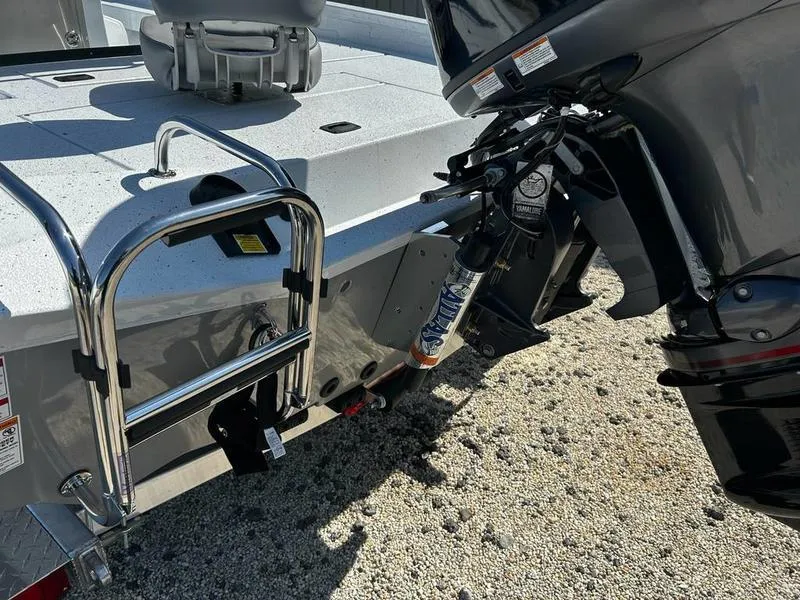 Slide: The Image of 2025 Xpress H20B boat with motor and ladder on gravel surface. - 10