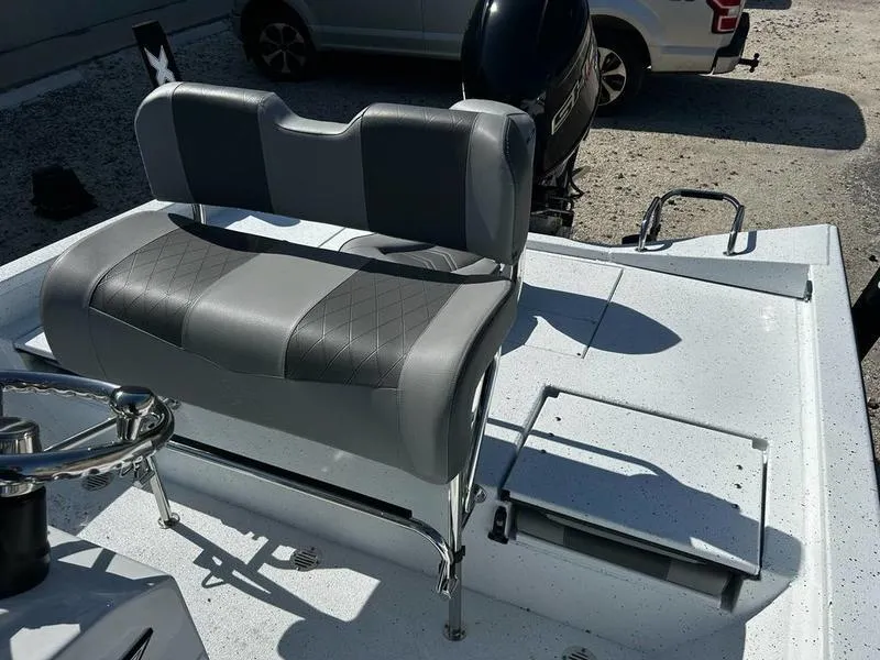 Slide: The Image of 2025 Xpress H20B boat interior with gray seating and steering wheel. - 12