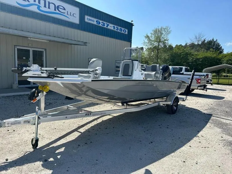 Slide: The Image of 2025 Xpress H20B boat on trailer outside a marine dealership. - 2
