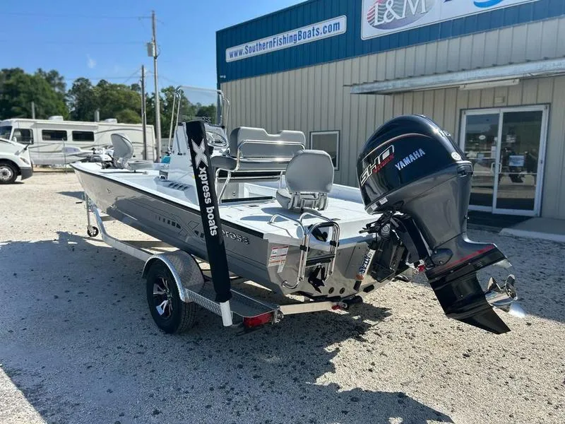 Slide: The Image of 2025 Xpress H20B boat with Yamaha engine, parked outside a dealership. - 3