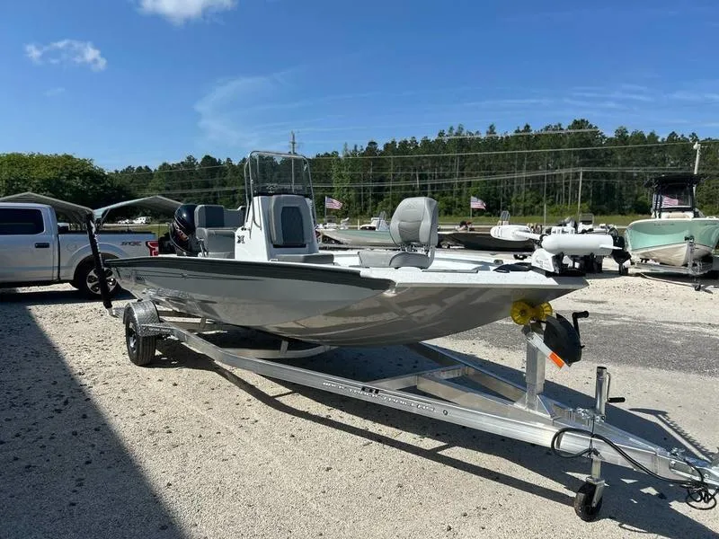 Slide: The Image of 2025 Xpress H20B boat on trailer, parked outdoors under clear blue sky. - 4