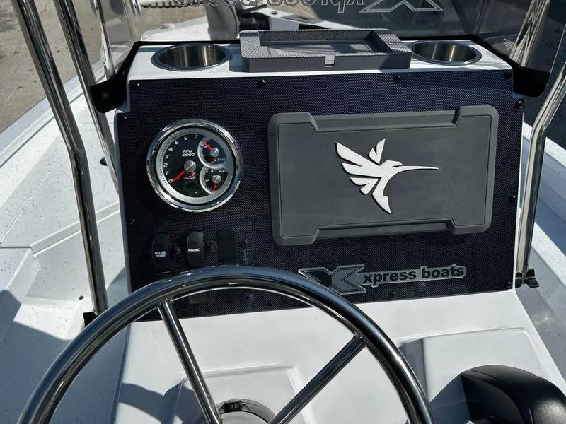 Slide: The Image of 2025 Xpress H20B boat dashboard with steering wheel and gauges. - 5