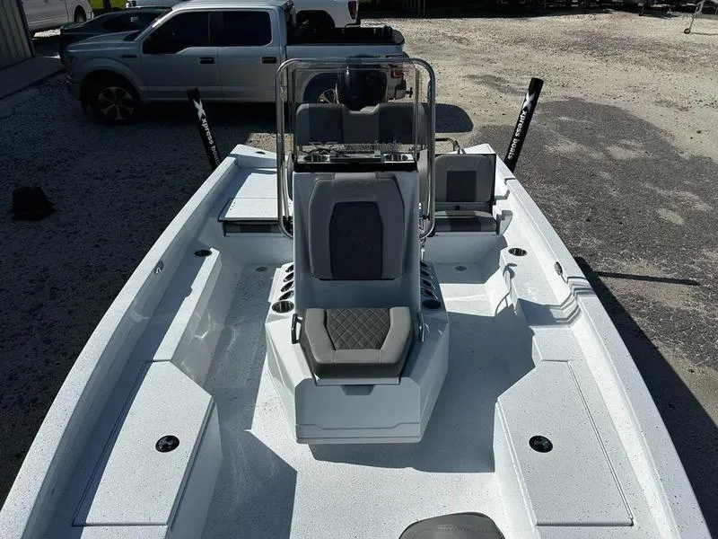 Slide: The Image of 2025 Xpress H20B boat with sleek design and modern seating, parked outdoors. - 8
