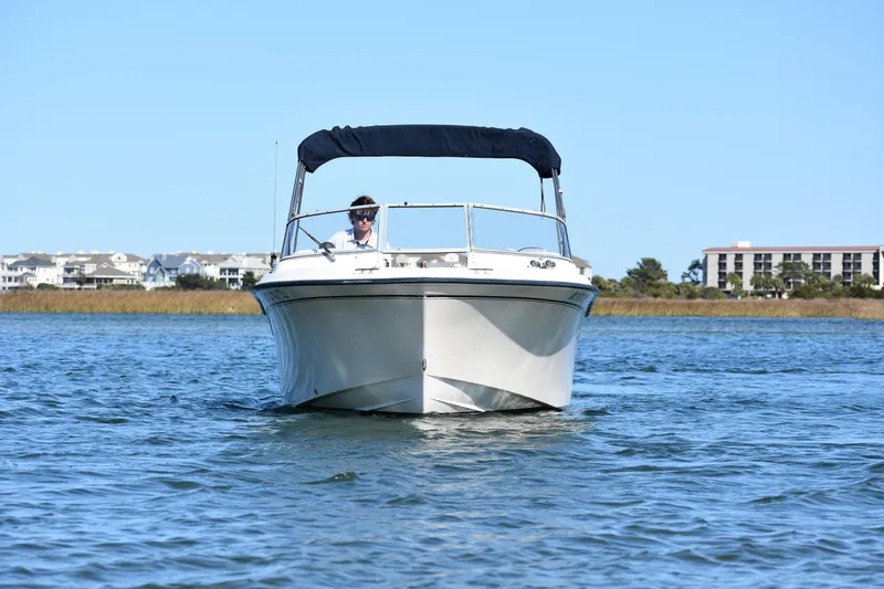 Slide: The Image of 2005 Grady-White 205 boat on water with buildings in background. - 2
