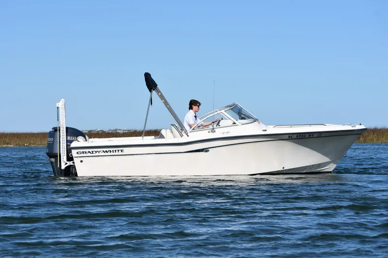 Slide: The Image of 2005 Grady-White 205 boat cruising on calm water under clear blue sky. - 3