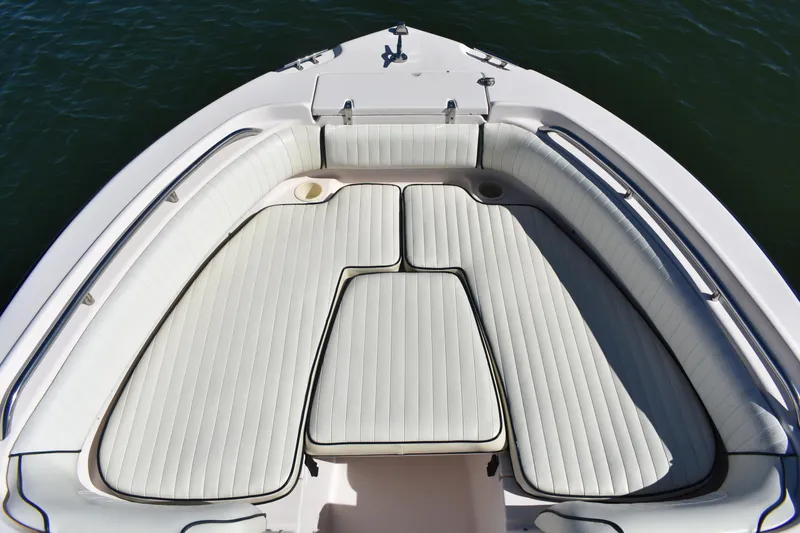 Slide: The Image of Bow seating area of a 2005 Grady-White 205 boat with white cushioned seats. - 4