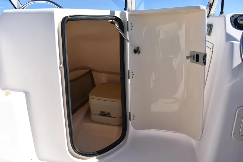 Slide: The Image of Open storage compartment on a 2005 Grady-White 205 boat, showing interior space. - 8