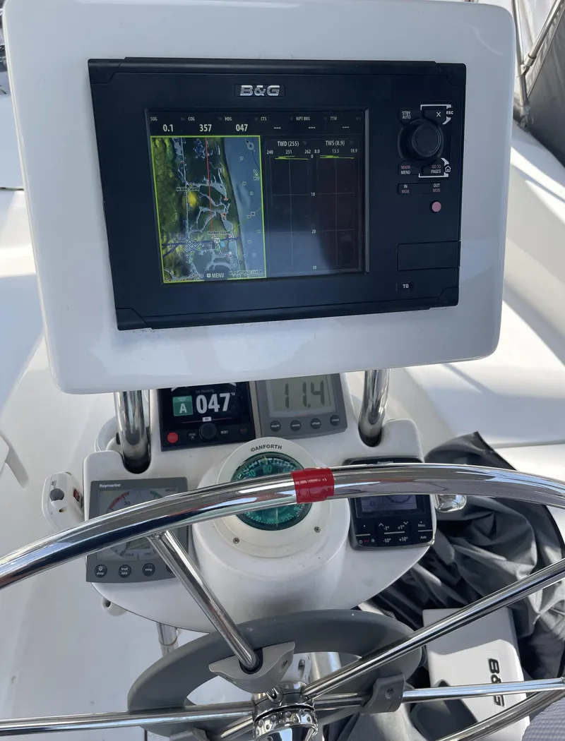 Slide: The Image of 2004 Hunter 36 sailboat helm with navigation equipment and steering wheel. - 10